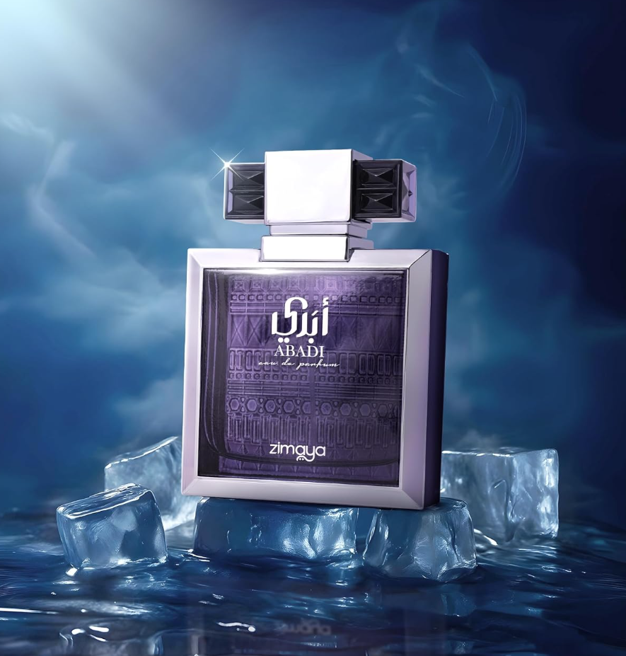 Zimaya Abadi Opulent purple bottle with silver frame and geometric cap standing on clear ice cubes, surrounded by blue mist above a reflective wet surface.