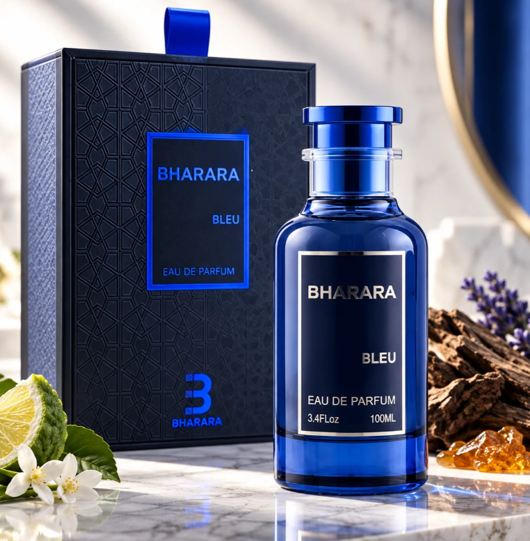 Bharara Bleu blue bottle with matching cap and dark patterned box on marble, surrounded by green citrus, white and purple flowers, wood pieces and amber-colored stones.
