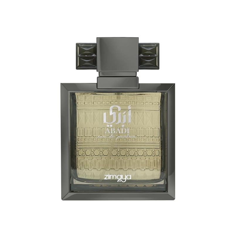 Zimaya Abadi rectangular perfume bottle with pale gold liquid, patterned glass, dark beveled frame and wide cap with faceted side wings, isolated on white.
