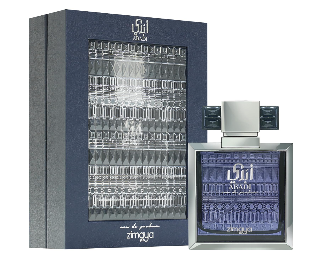 Zimaya Abadi Opulent purple patterned perfume bottle with silver beveled frame and wide geometric cap, beside its dark blue box with silver decorative panel on white.