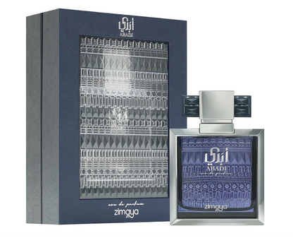 Zimaya Abadi Opulent purple patterned perfume bottle with silver beveled frame and wide geometric cap, beside its dark blue box with silver decorative panel on white.