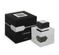 Al Haramain L'Aventure silver square perfume bottle with an amber glass window and black cap beside a black box with silver geometric detailing on white.
