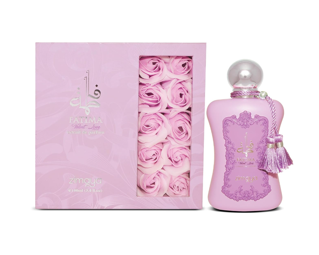 Zimaya Fatima Velvet Love pink curved perfume bottle with silver ball cap, ornate purple front design and twin tassels, beside its pink box with rose graphics on white.
