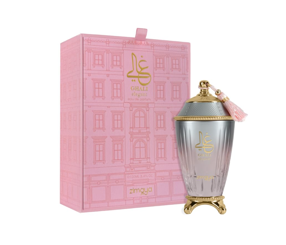 Zimaya Ghali Elegant fluted silver-to-pink urn-shaped bottle with gold feet, domed cap and pink tassel, beside its pink architectural-patterned box on white.