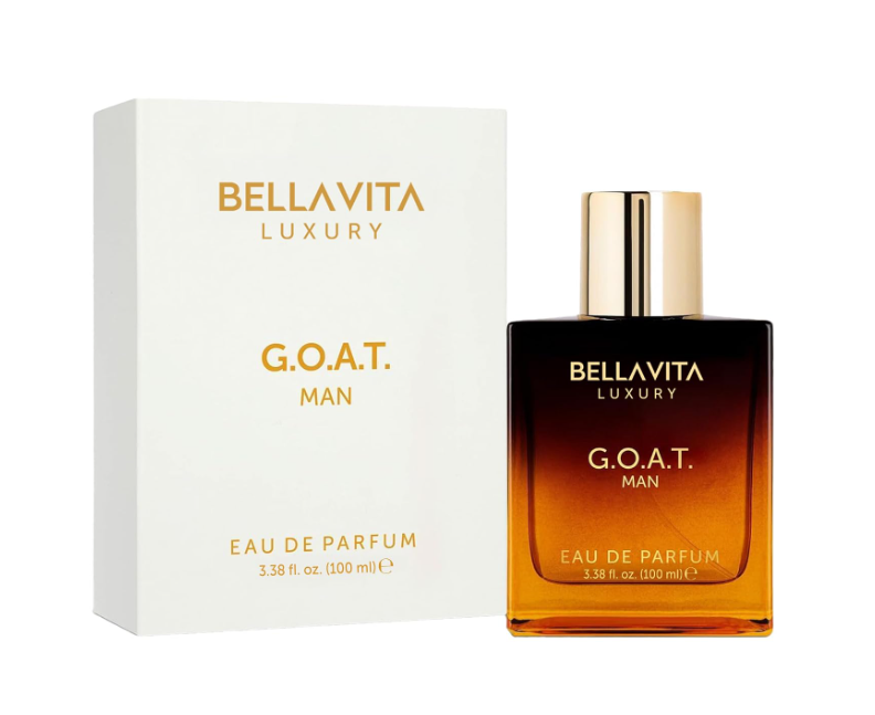 Bellavita Luxury G.O.A.T. Man perfume bottle fading from dark brown to amber, with a gold cap, beside its white and gold box on a white background.