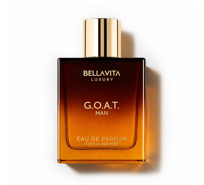 Bellavita G.O.A.T. Man amber-gradient rectangular perfume bottle with gold lettering and a reflective gold cap, casting a shadow on white.