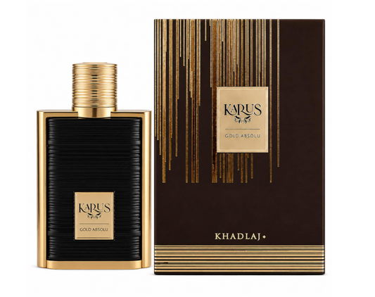 Khadlaj Karus Gold Absolu black ribbed rectangular perfume bottle with gold frame, gold plaque and ridged cylindrical gold cap, beside its brown-and-gold box on white.