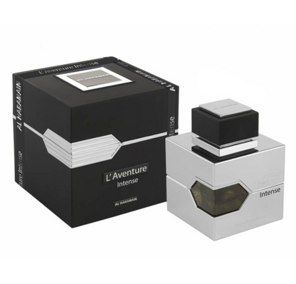 Al Haramain L'Aventure Intense silver square perfume bottle with an angular amber window and black cap beside a black box with silver detailing on white.