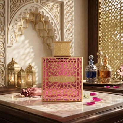 Rayhaan Kiss pink bottle on an ornate vanity with petals and a gold arch