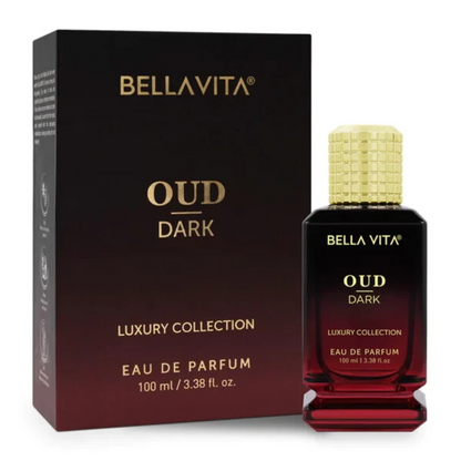Bellavita Oud Dark black-to-burgundy perfume bottle with a textured gold cap and stepped base beside its matching dark box on white.