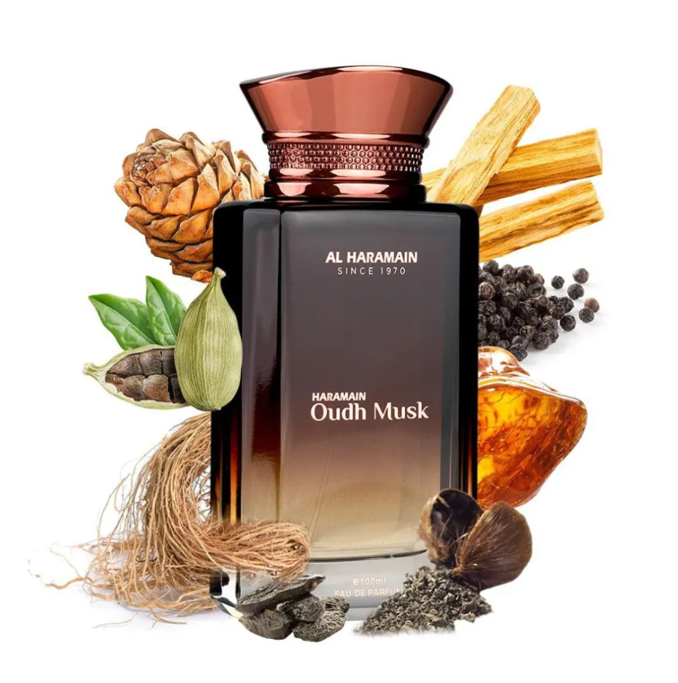 Al Haramain Oudh Musk bottle with a copper-colored cap surrounded by cardamom pods, peppercorns, wood, roots, a cone and amber-colored resin graphics on white.