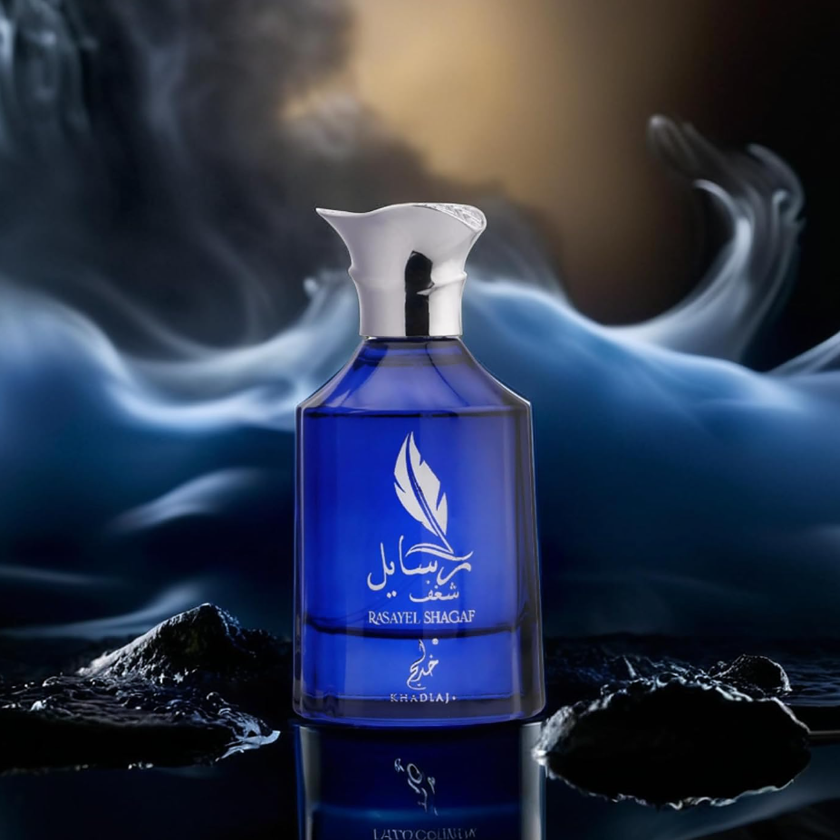 Khadlaj Rasayel Shagaf blue bottle displayed on black rocks against blue smoke