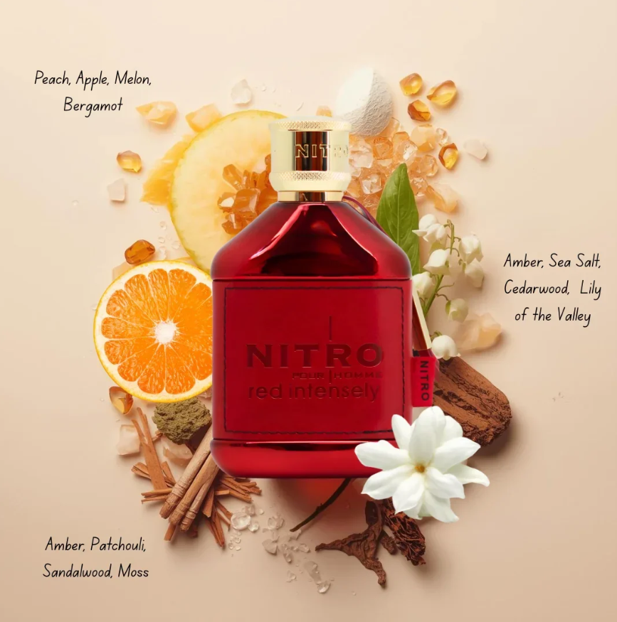 Dumont Nitro Red Intensely red bottle with gold cap on beige, surrounded by fruit, white flowers, wood and amber-colored pieces, with printed fragrance-note labels.