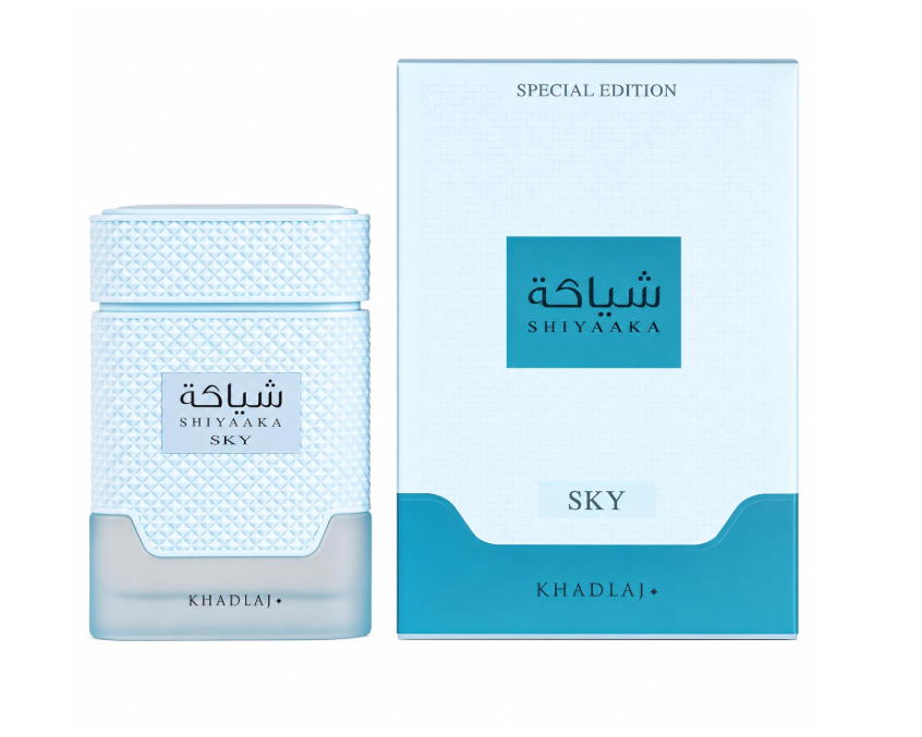 Khadlaj Special Edition Shiyaaka Sky light blue perfume bottle with diamond-textured body and wide matching cap, beside its pale blue-and-turquoise box on white.