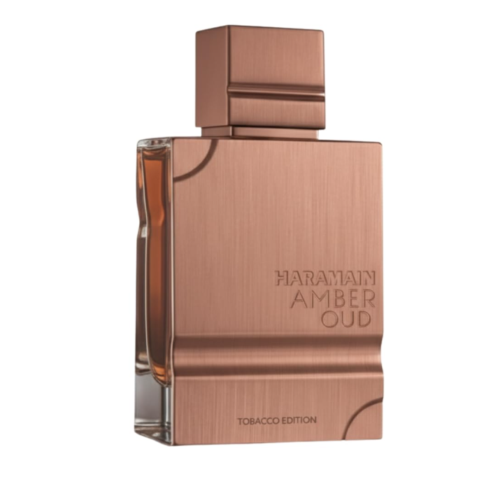 Al Haramain Amber Oud Tobacco Edition bottle with a brushed copper-colored front, matching square cap and clear glass side on a white background.