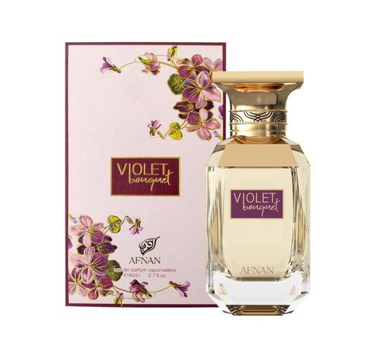 Afnan Violet Bouquet clear faceted perfume bottle with pale yellow liquid and broad gold cap, beside its cream box with purple flowers and burgundy border on white.