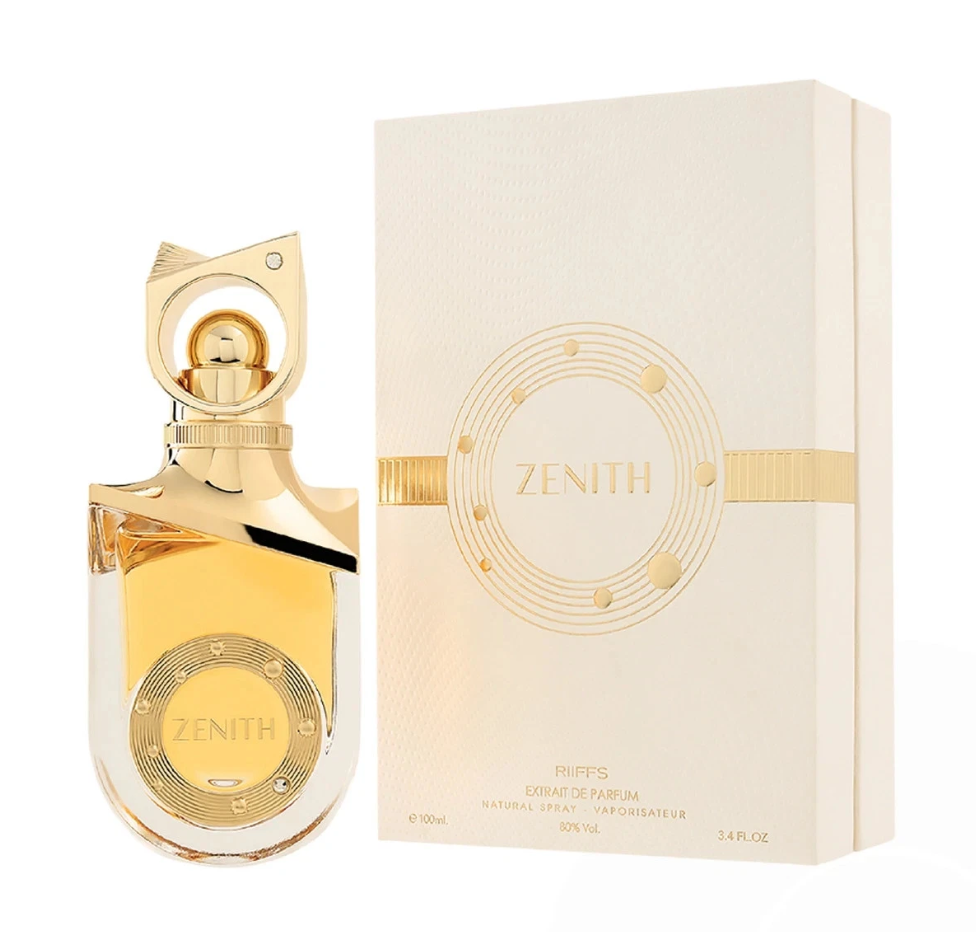 Riiffs Zenith clear rounded perfume bottle with golden liquid, metallic shoulder detail and sculptural circular gold cap, beside its cream-and-gold box on white.